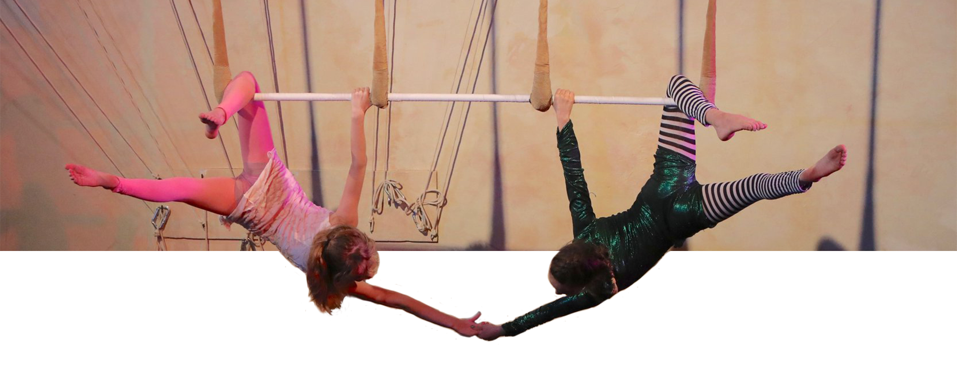 bar-hanging-hand-holding Two Students hanging from bars and holding hands